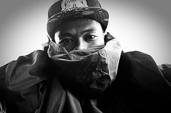 Black and white portrait of a man wearing a cap and jacket
