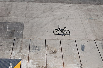 High angle view of bicycle on concrete parking lot