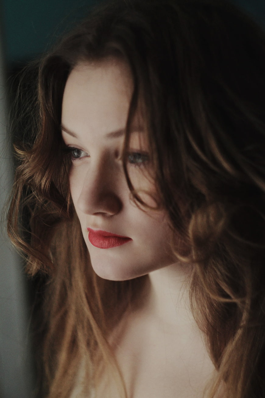Moody Portrait of Woman with Red Lips and Wavy Hair