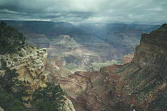 Dramatic Grand Canyon landscape with storm clouds and sunbeams