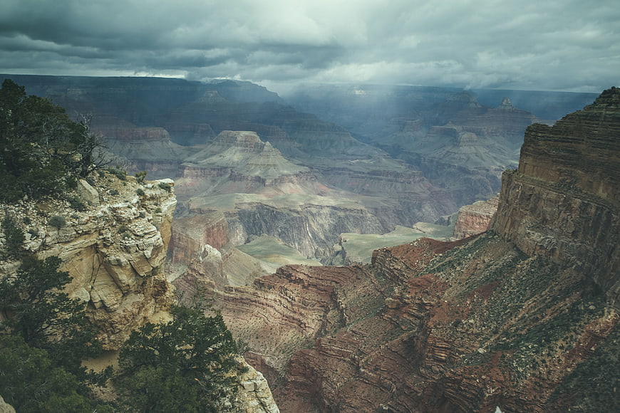 Dramatic Grand Canyon landscape with storm clouds and sunbeams