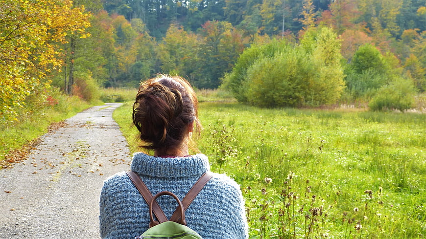Woman Walking on Path in Autumn Forest