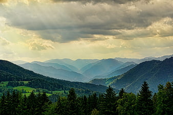 Dramatic Mountain Landscape With Sunbeams And Forested Hills