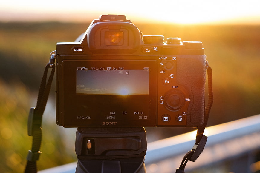 Sony Camera on Tripod Capturing Golden Hour Sunset