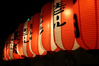 Glowing red and white Japanese lanterns at night