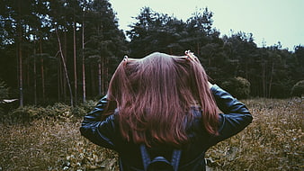 Woman with Pink Hair in Leather Jacket Facing Forest