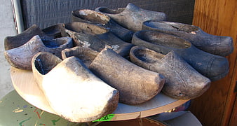 Collection of antique wooden clogs on a table