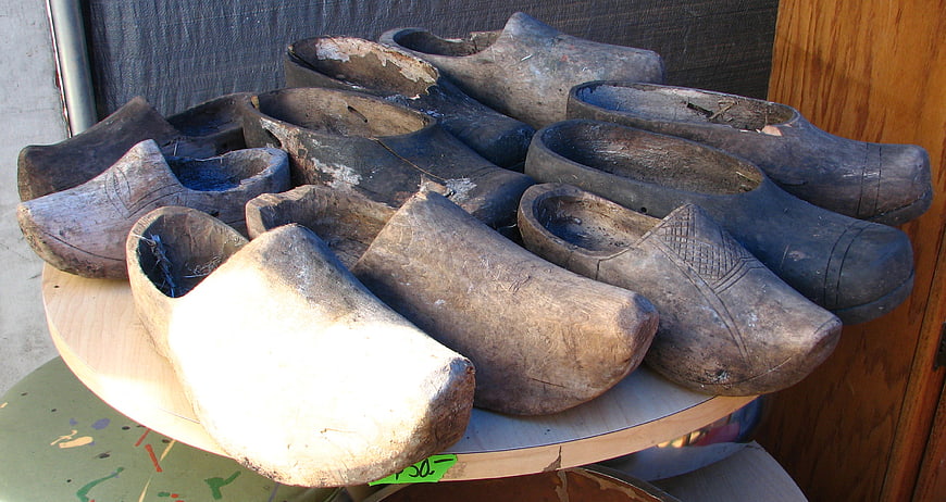 Collection of antique wooden clogs on a table