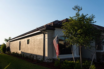 Modern House Exterior with American Flag and Landscaping