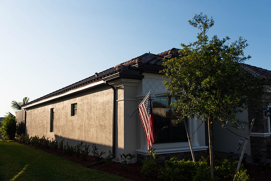 Modern House Exterior with American Flag and Landscaping