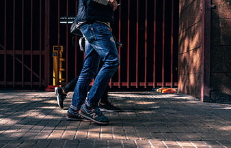 Low angle shot of people walking on urban sidewalk