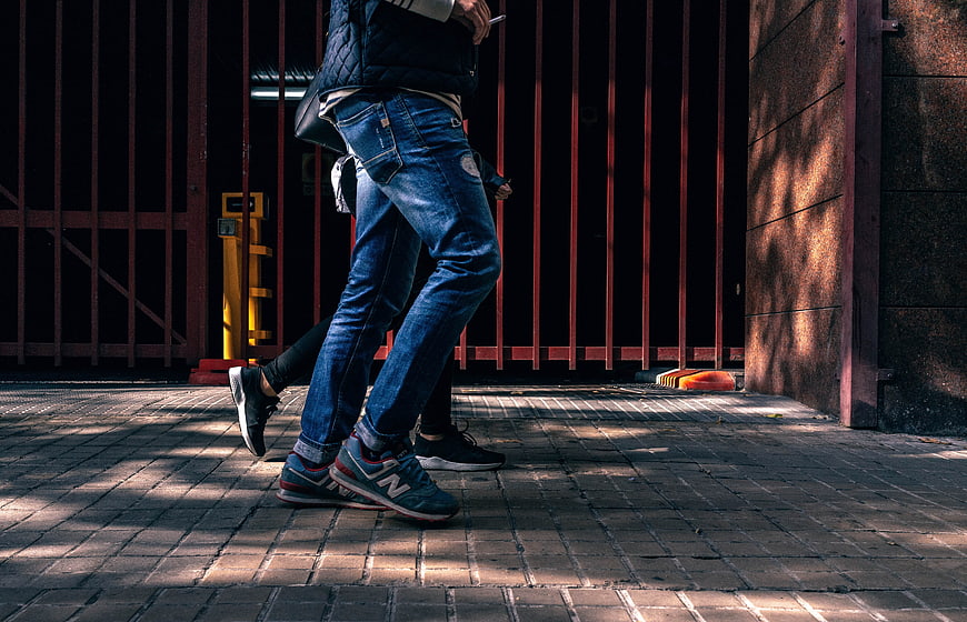 Low angle shot of people walking on urban sidewalk