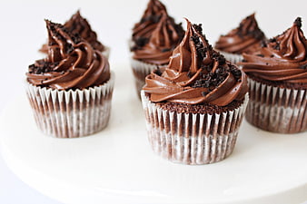 Chocolate Cupcakes with Ganache and Cookie Crumbs on White Plate