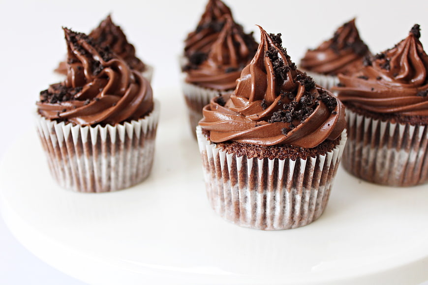 Chocolate Cupcakes with Ganache and Cookie Crumbs on White Plate