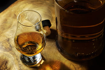 Whiskey Snifter and Decanter on Rustic Wooden Table