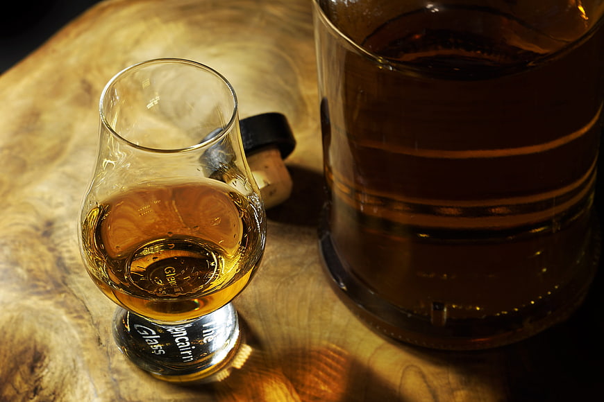 Whiskey Snifter and Decanter on Rustic Wooden Table
