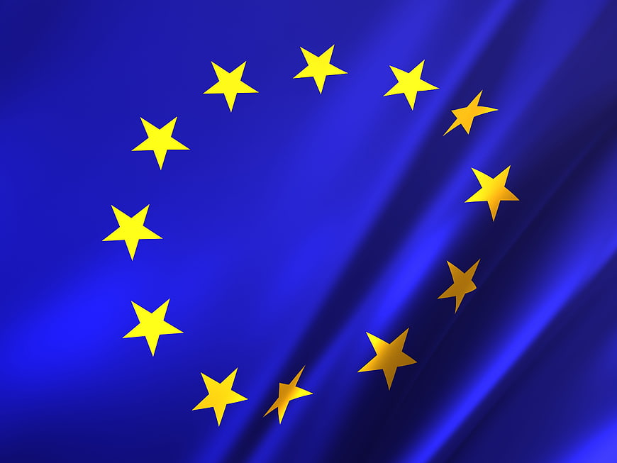 European Union Flag Waving on Blue Background