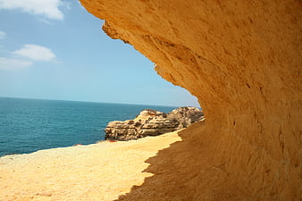 View from inside a coastal sea cave looking out to the ocean