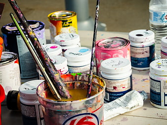 Used Paint Brushes and Cans on Art Table