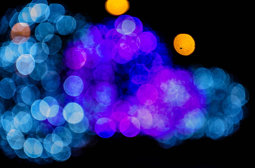 Abstract blue and purple bokeh lights on black background