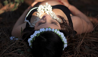 Woman with Flower Crown Lying on Pine Needles