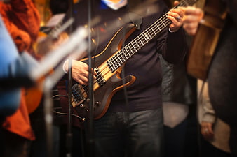 Musician Playing Electric Bass Guitar on Stage