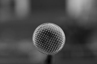 Close-up of a microphone grille in black and white