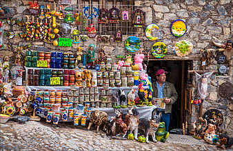 Man Reading Newspaper At Colorful Mexican Souvenir Market Stall
