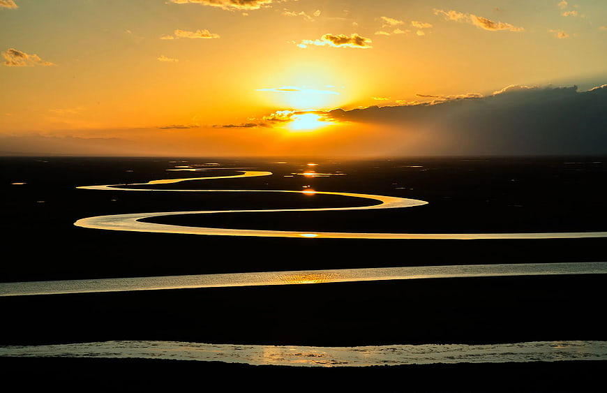 Golden Sunset Over Winding River Landscape
