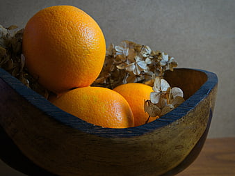Fresh Oranges in Rustic Wooden Bowl with Dried Flowers