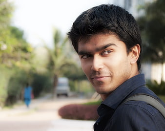 Portrait of a young man with a backpack outdoors