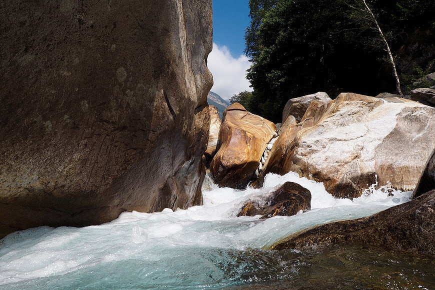Turquoise river flowing through rocky gorge in Verzasca Valley