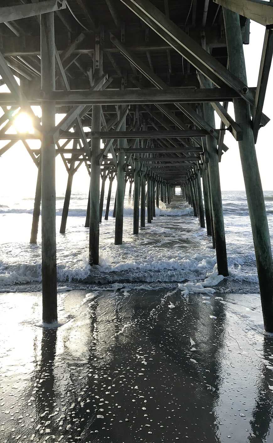 Sunlight Under Wooden Pier at Beach