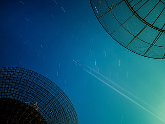 Star Trails Above Radio Telescope Dishes at Night
