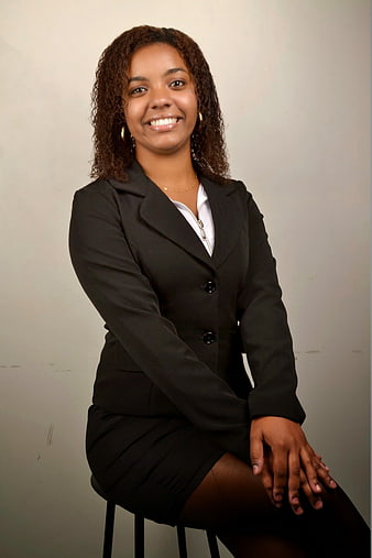 Professional Portrait of Smiling Businesswoman in Black Suit