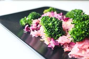 Steamed broccoli and red cabbage salad on black plate