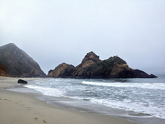 Foggy Rocky Beach Landscape with Ocean Waves