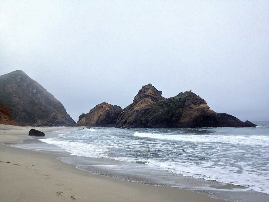 Foggy Rocky Beach Landscape with Ocean Waves