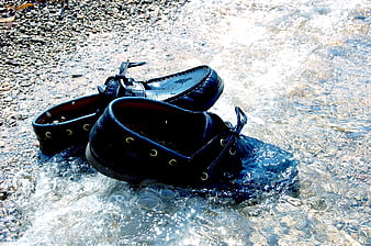 Black Leather Boat Shoes in Flowing Stream Water