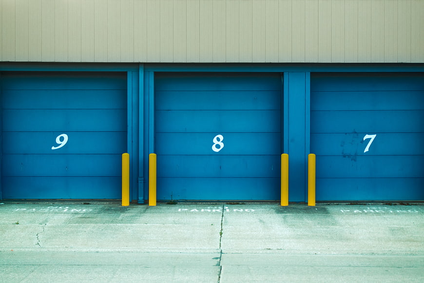 Blue Industrial Garage Doors with Yellow Bollards