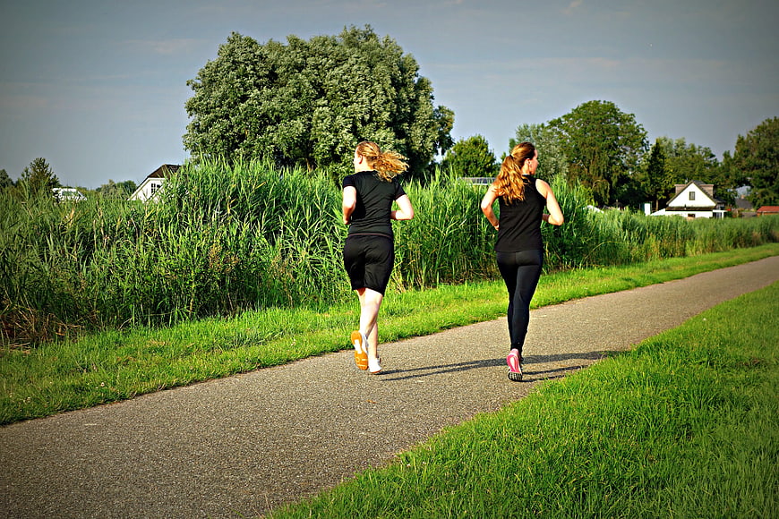 Two Women Jogging on a Path in Nature