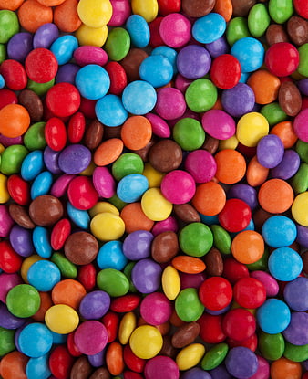 Colorful candy coated chocolates background texture