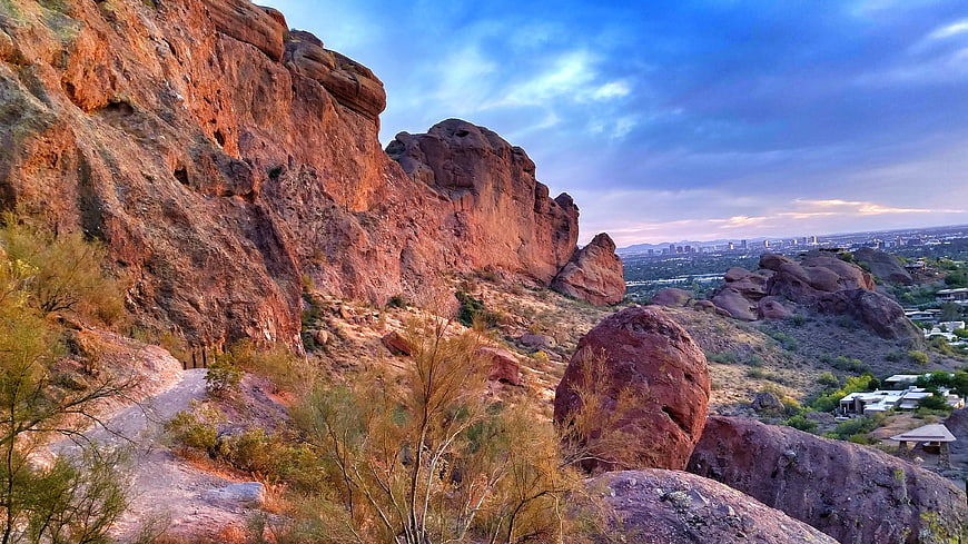 Red Rock Desert Landscape with City Skyline at Sunset
