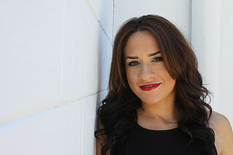 Portrait of Brunette Woman with Red Lipstick Against White Wall