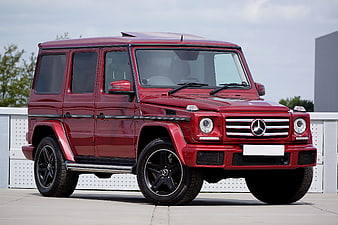 Red Mercedes-Benz G-Class SUV parked on concrete