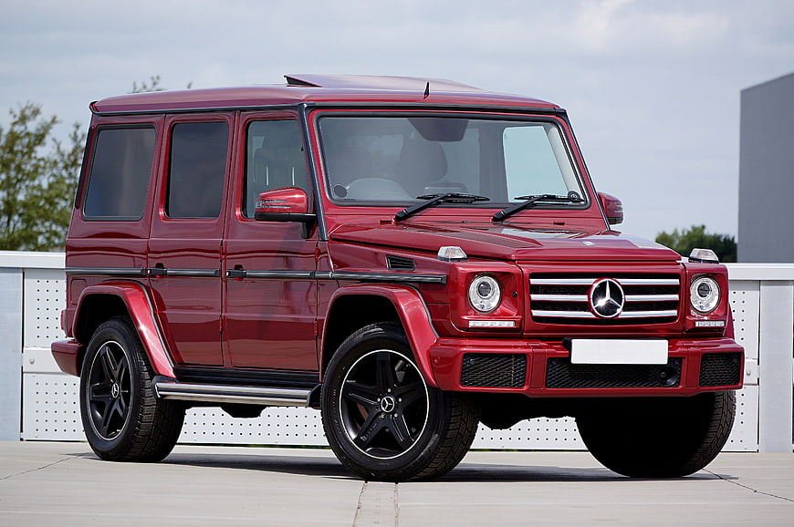 Red Mercedes-Benz G-Class SUV parked on concrete