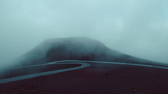 Winding Road Through Foggy Mountain Landscape