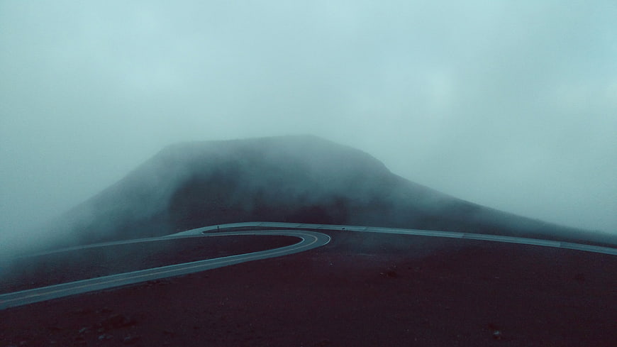 Winding Road Through Foggy Mountain Landscape