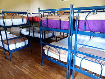 Blue metal bunk beds in a youth hostel dormitory room