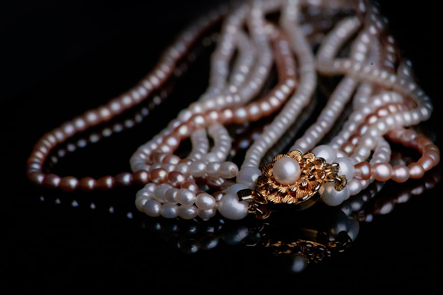 Luxurious Gold and Pearl Necklace on Black Background